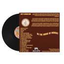 Vinyl record with brown label featuring tracklist and album design elements on a white background