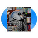 Kevin Abstract Album cover for Blush with a person wrapped in a blanket and headphones, surrounded by books on a shelf.