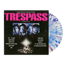 Vinyl record with 'Trespass' album cover featuring a black background and colorful disc.