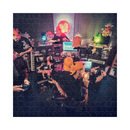 Jigsaw puzzle with a completed image of people in a studio setting.